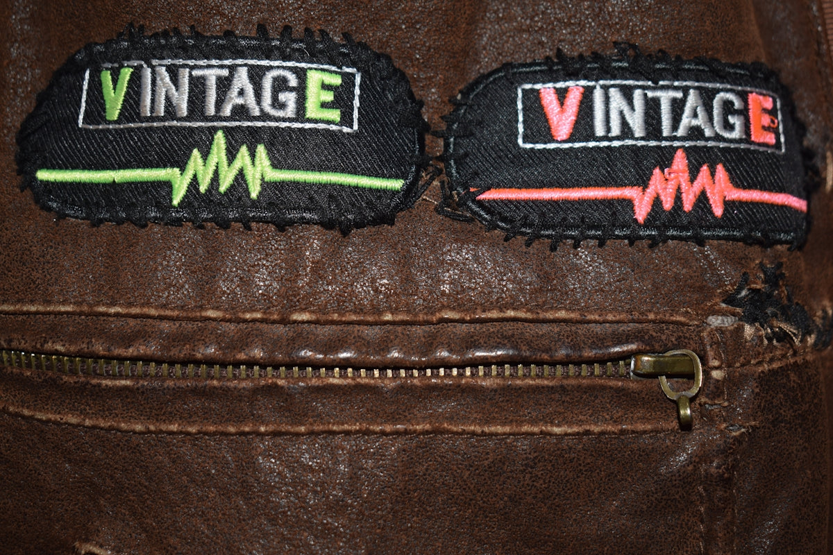 Two vintage patches on a brown leather jacket